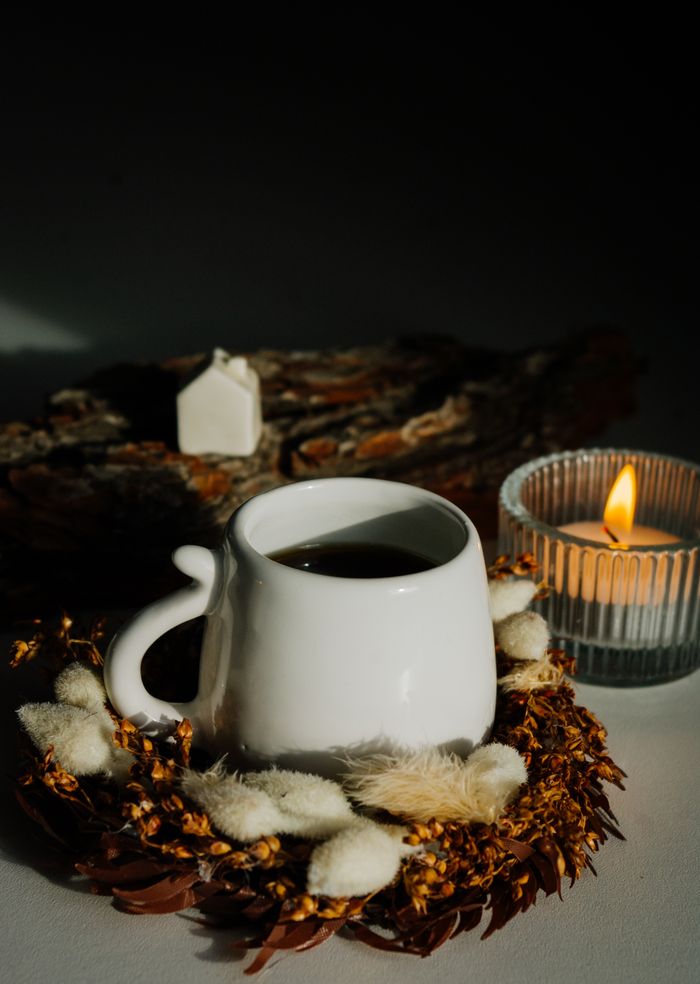 Crafting Captivating Headlines: Your awesome post title goes here A warm and inviting still life of coffee, candle, and decor for relaxation.